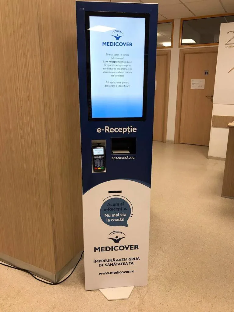 The e-Reception infokiosk in a Medicover clinic: touchscreen, ID card scanner and POS terminal for card payment